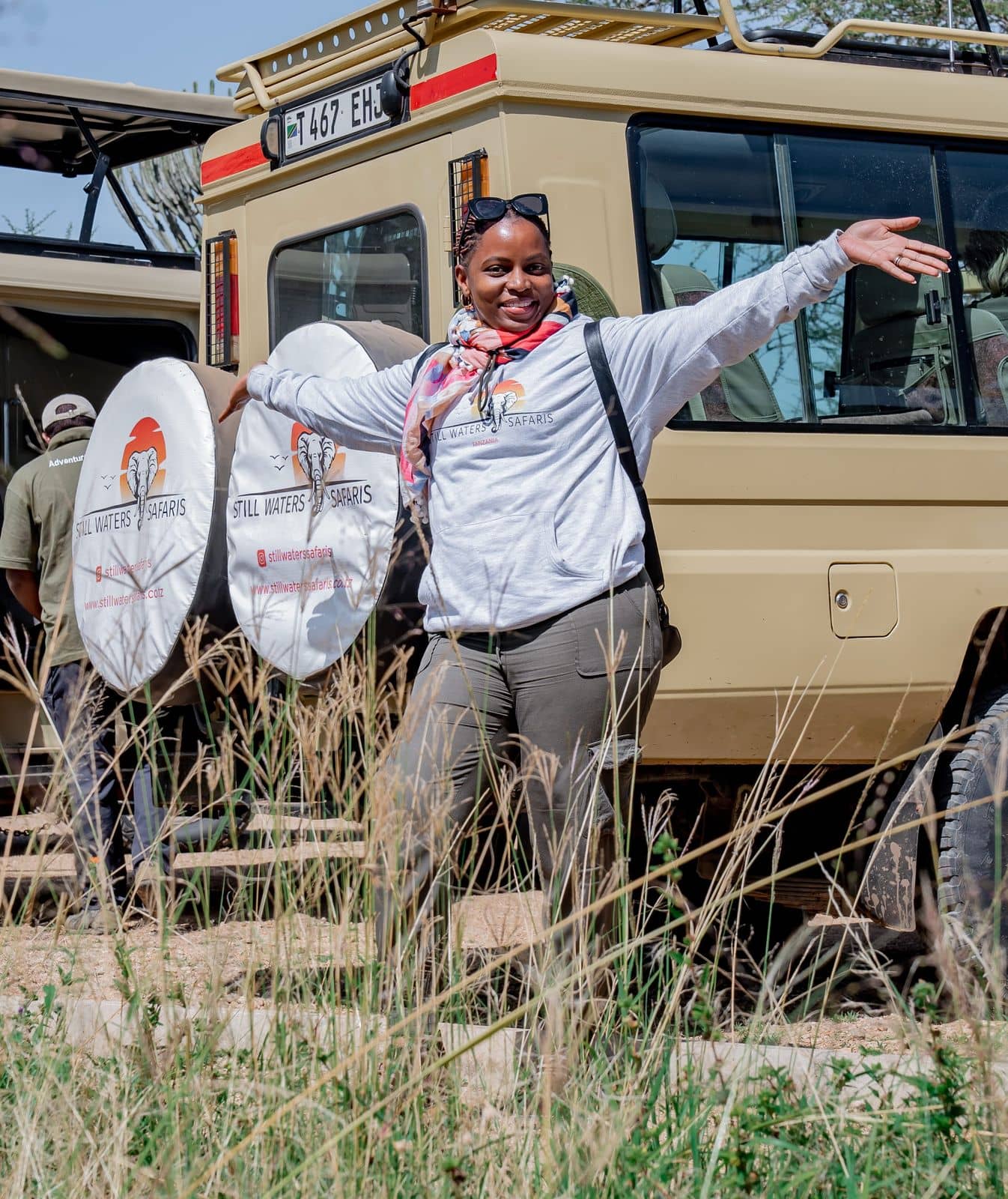 Amanda Kessy welcoming guests beside a Still Waters Safaris Land Cruiser